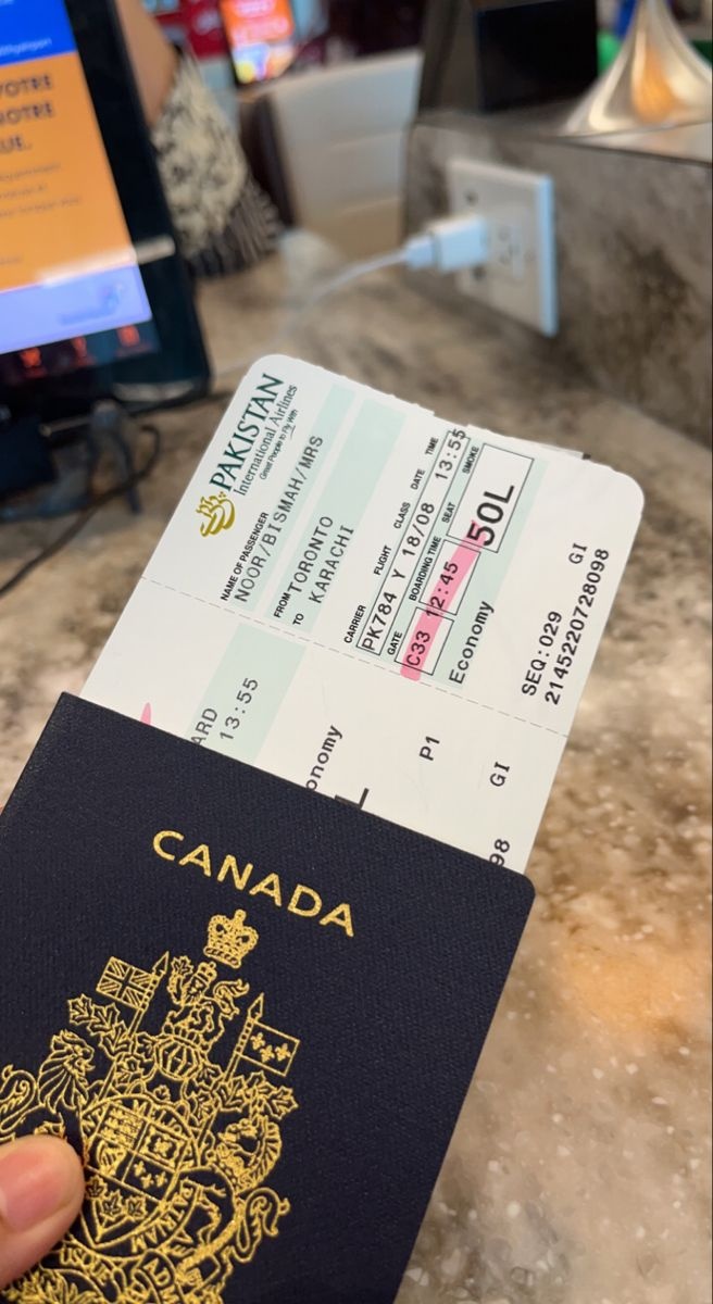 Travel documents and a Canadian passport in an airport setting